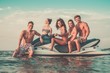 Group of multi ethnic friends sitting on a jet ski