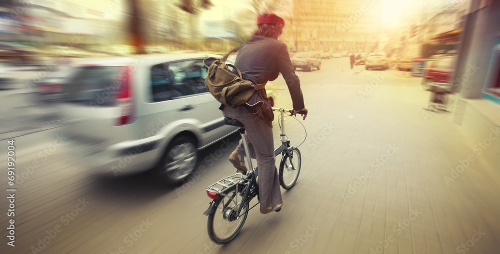 cyclist in traffic on the city roadway motion blur - obrazy, fototapety, plakaty 
