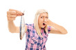 Blond woman holding a stinky fish
