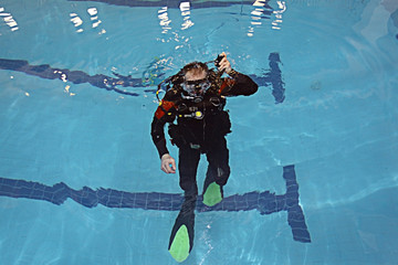 Poster - man teaches diving in the pool, swim coach