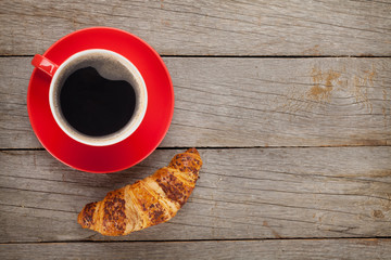 Cup of coffee and fresh croissant