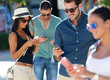 © nenetus - Portrait of group of friends having fun with smartphones.