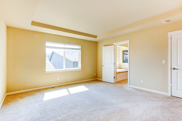 Empty master bedroom with bathroom