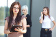 © photoniko - a group of businesswomеn from tablets on the street