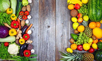 Huge group of fresh vegetables and fruit on wooden background -