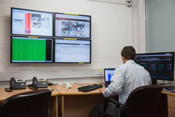 Poster - Technician sitting in office running diagnostics