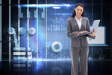 Wall Mural - Composite image of businesswoman smiling with a laptop