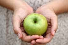Woman's Hands Holding A Green Apple