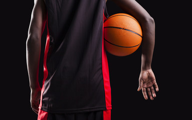 Wall Mural - Rear view of a basketball player standing with a basket ball on