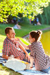 © Kostiantyn - happy young couple enjoying picnic. Toned image
