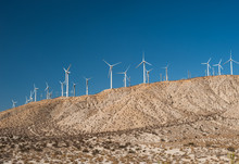 Wind Turbines In Desert Landscape