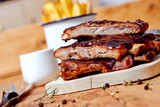 Barbecue ribs on vintage wooden table with french fries