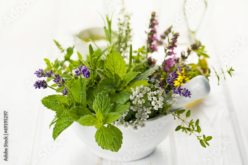 Fototapeta na wymiar Fresh herbs in mortar