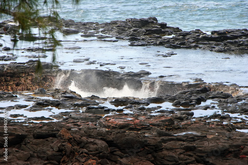 Fotografie, Obraz Water Shooting Upward From Spouting Horn Blowhole Kauai Hawaii
