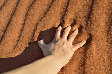 close up of hand on the desert sand