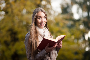 Poster - female student holding book