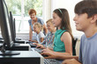 © highwaystarz - Group Of Elementary Pupils In Computer Class With Teacher