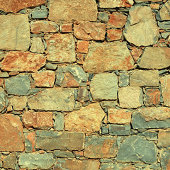 Wall Mural - rough mediterranean stone wall as background.