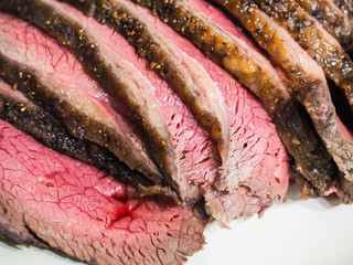 Fried seasoned juicy red meat on white plate