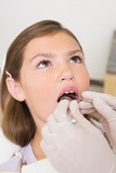 Fototapeta Do pokoju - Pediatric dentist examining little girls teeth