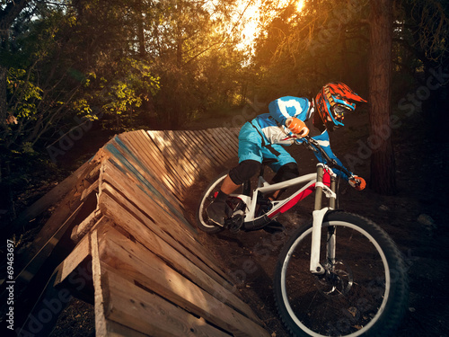 Fotografia, Obraz  Cyclist riding mountain bike downhill style.