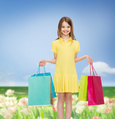 Canvas Print - smiling little girl in dress with shopping bags