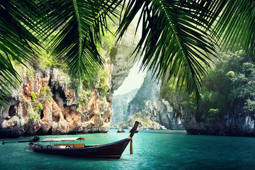 Wall Mural - long boat and rocks on beach in Krabi, Thailand