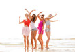 © Syda Productions - group of smiling women dancing on beach