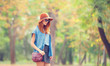 © Masson - Redhead girl in sunglasses and hat in the autumn park.