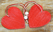 Two Red Wooden Hearts On Wooden Surface