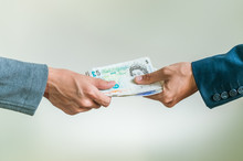 Businessmen Exchanging British Money Pounds Sterling