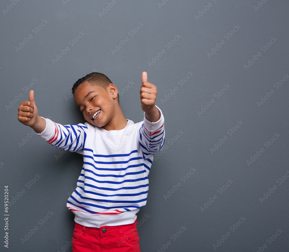 Cute little boy smiling with thumbs up sign Stock Photo | Adobe Stock