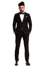 Man Wearing Tuxedo Standing With Hands In Pockets