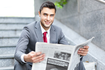 Business man reading a newspaper