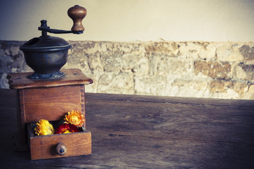 Vintage wooden coffee mill grinder with yellow flowers