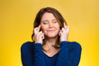 Woman, mother crossing her fingers on yellow background 