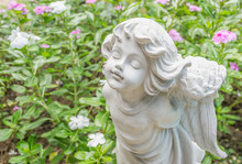 Fairy Statue In The Garden With Flower