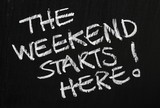 Fototapeta  - The weekend starts here! on a blackboard