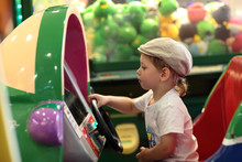 Boy Playing Arcade Game Machine