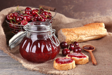 Sticker - Berries jam in glass jar on table, close-up