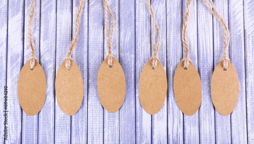 Brown tags on wooden background