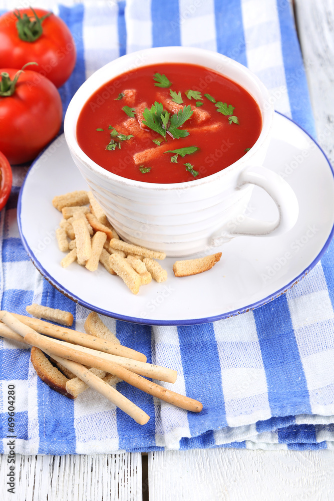 Tasty tomato soup with croutons on table close-up