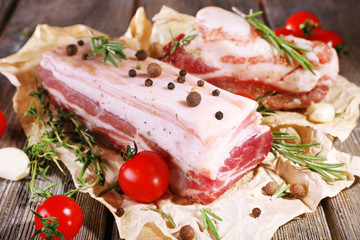 Poster - raw bacon with spices and tomatoes on wooden table