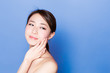 © taka - beautiful asian woman on blue background