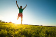 © fotomaximum - Young man jumping on meadow with dandelions