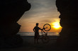 Man and bike at sunset, Bay of Bengal, Burma (Myanmar)