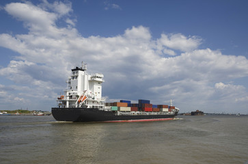 Cargo ship sailing in still water