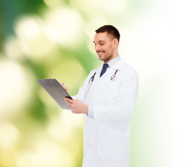 Wall Mural - smiling male doctor with clipboard and stethoscope