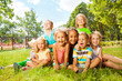 © Sergey Novikov - Group of happy little kids on the lawn in park