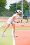 Fototapeta Sport - Focused tennis player ready to serve